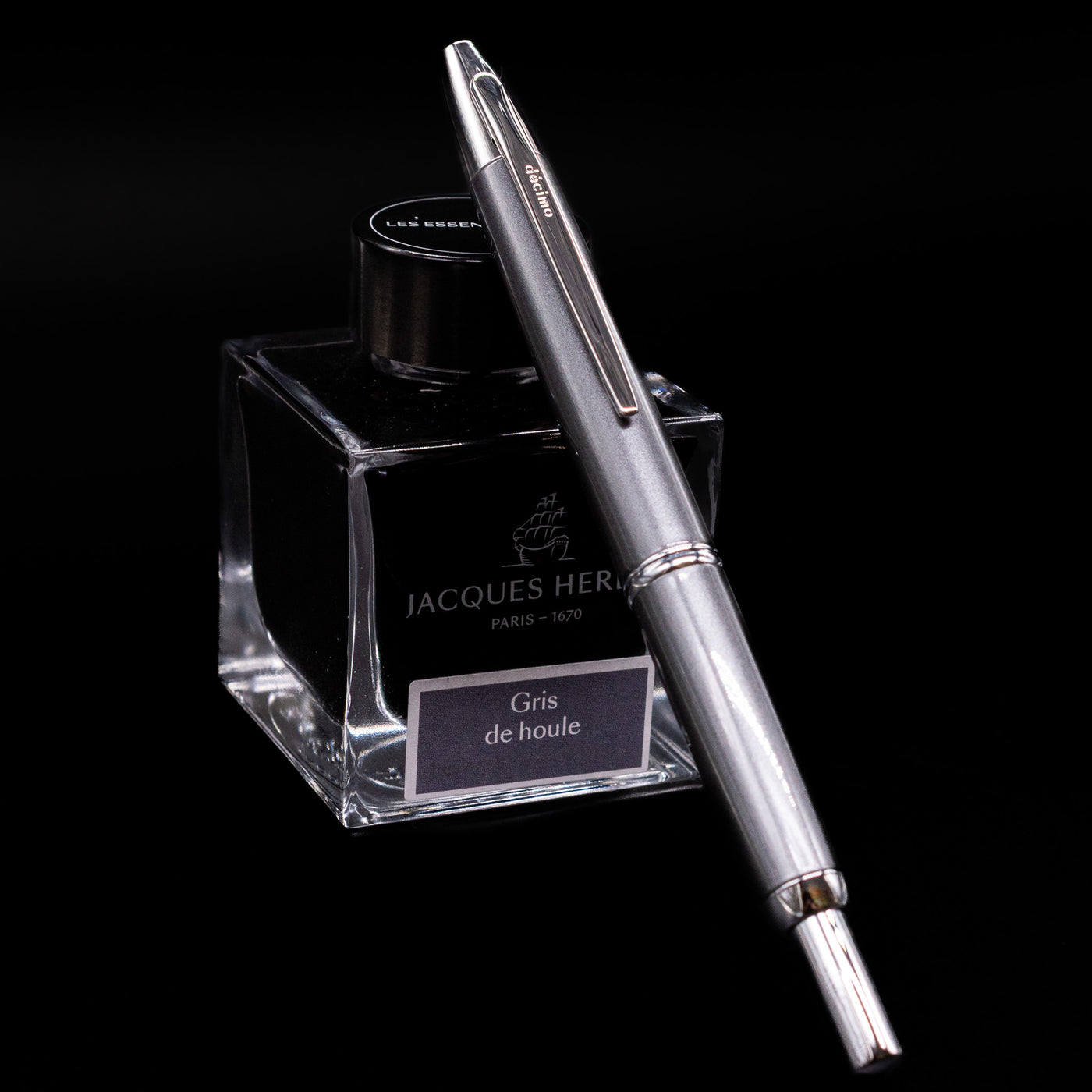 Grey Pilot Vanishing Point Decimo Fountain Pen angled on top of Jacques Herbin ink bottle