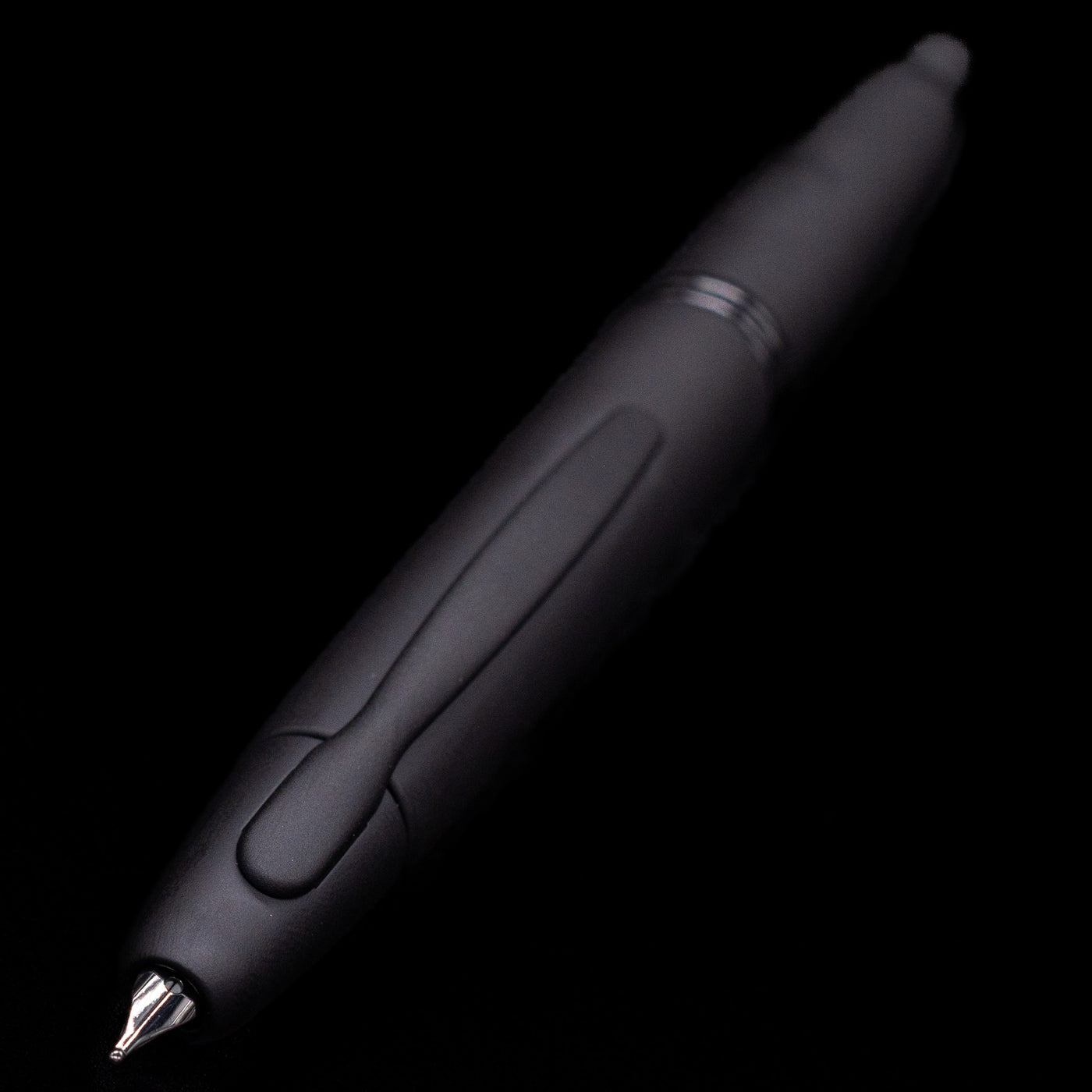 Close-up of Pilot Vanishing Point Fountain Pen in Black Matte with nib retracted on black background