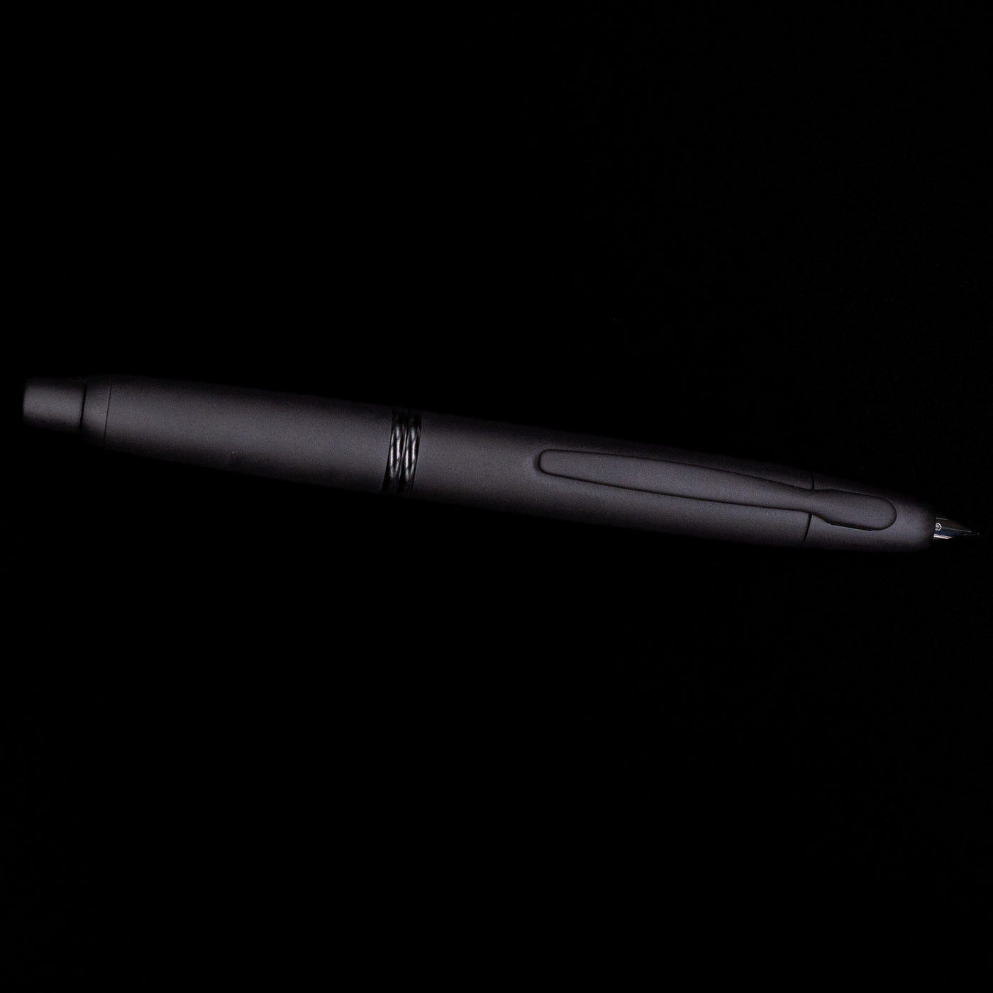 Side view of Pilot Vanishing Point Fountain Pen in Black Matte with nib extended on black background
