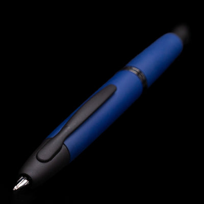 Close-up of the nib and clip of the Pilot Vanishing Point Fountain Pen Matte Blue against a dark background.