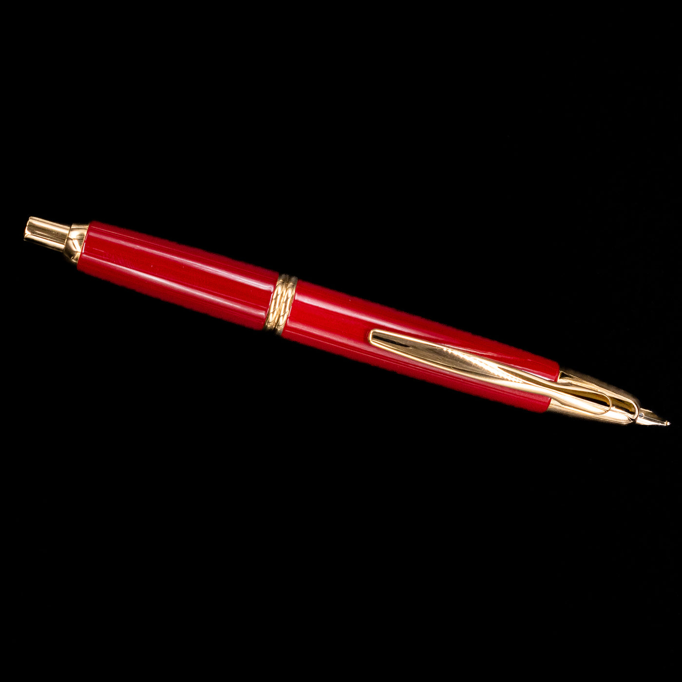 Full-length image of Pilot Vanishing Point Fountain Pen in Red and Gold against black background