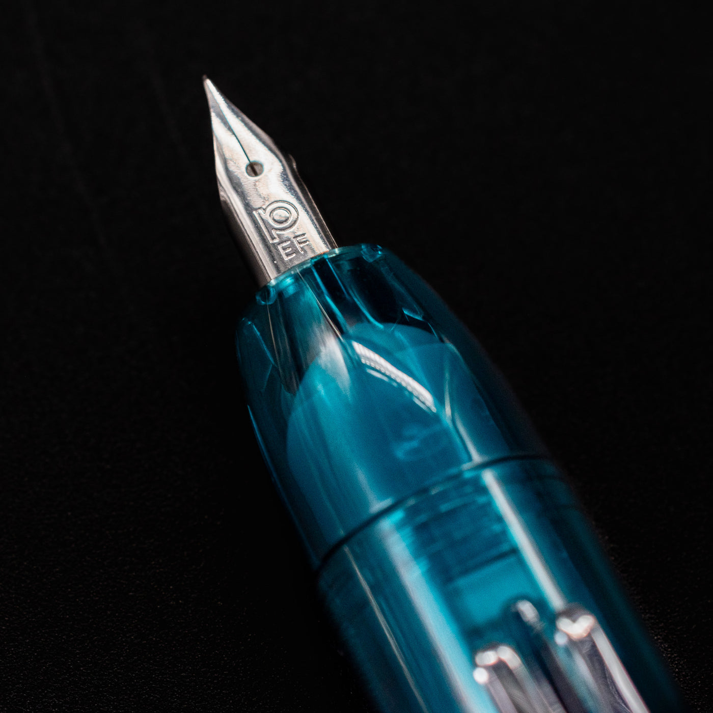 Close-up of the Platinum Curidas Urban Green fountain pen's extra fine nib with engraved Platinum logo.