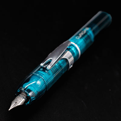 Side view of the Platinum Curidas Urban Green fountain pen highlighting its transparent body and stainless steel nib.