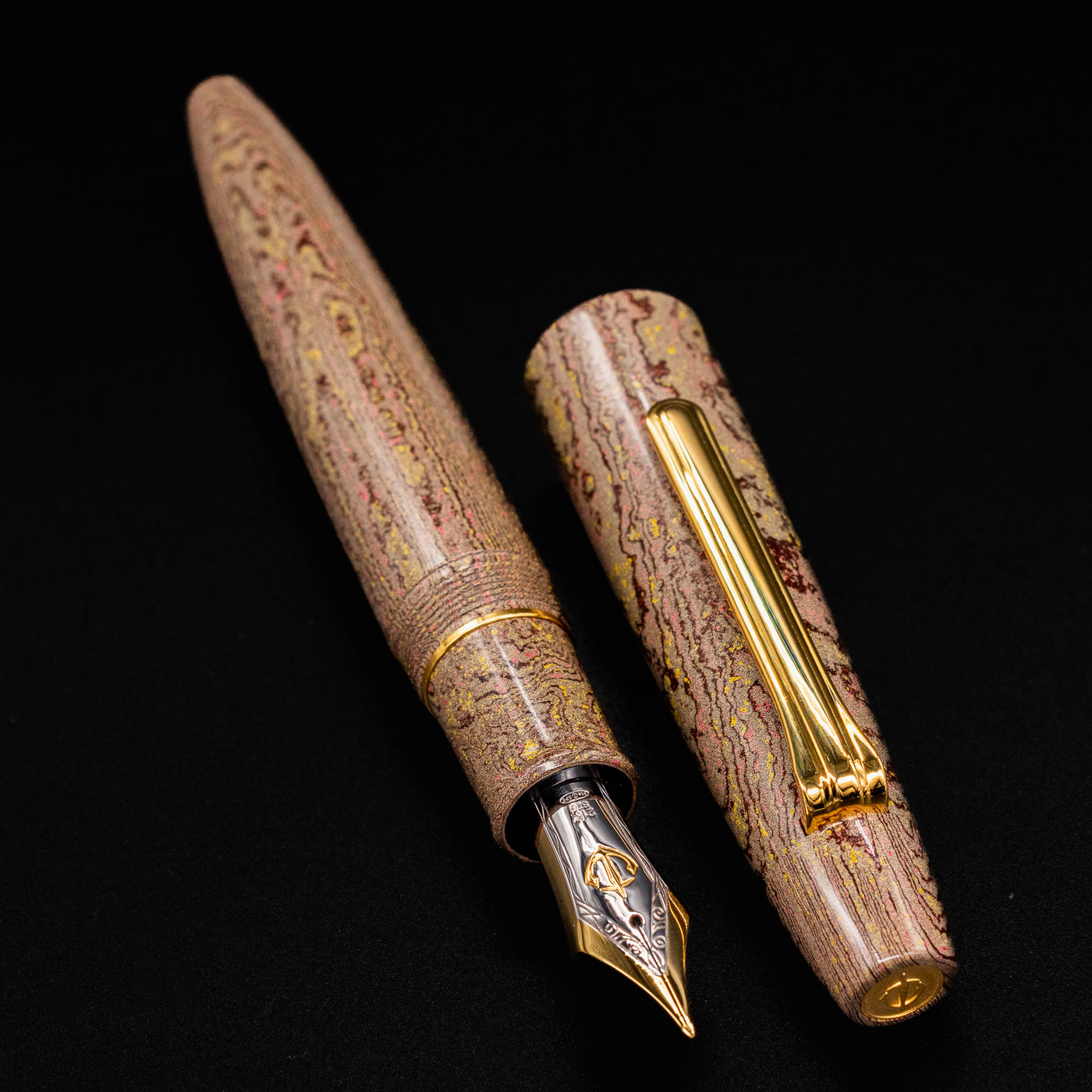 Sailor King of Pens Naginata Togi Syokei Fountain Pen with cap removed, showing the 21k nib and textured brown and gold ebonite body on a black background.