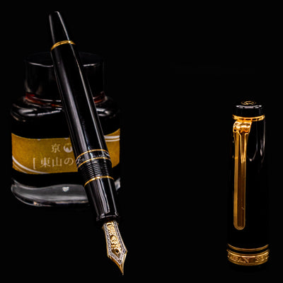Sailor Professional Gear Realo Black Fountain Pen nib angled over ink bottle – Preowned luxury Japanese fountain pen