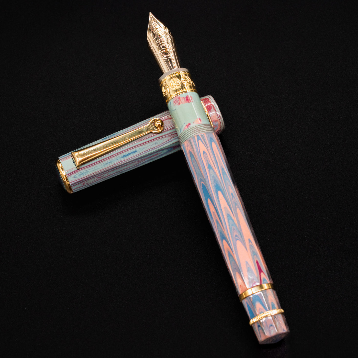Top-down view of the Santini Giant 8 Faceted Burano Fountain Pen with cap unposted, showing the pastel marbled body and gold-plated nib and trim.