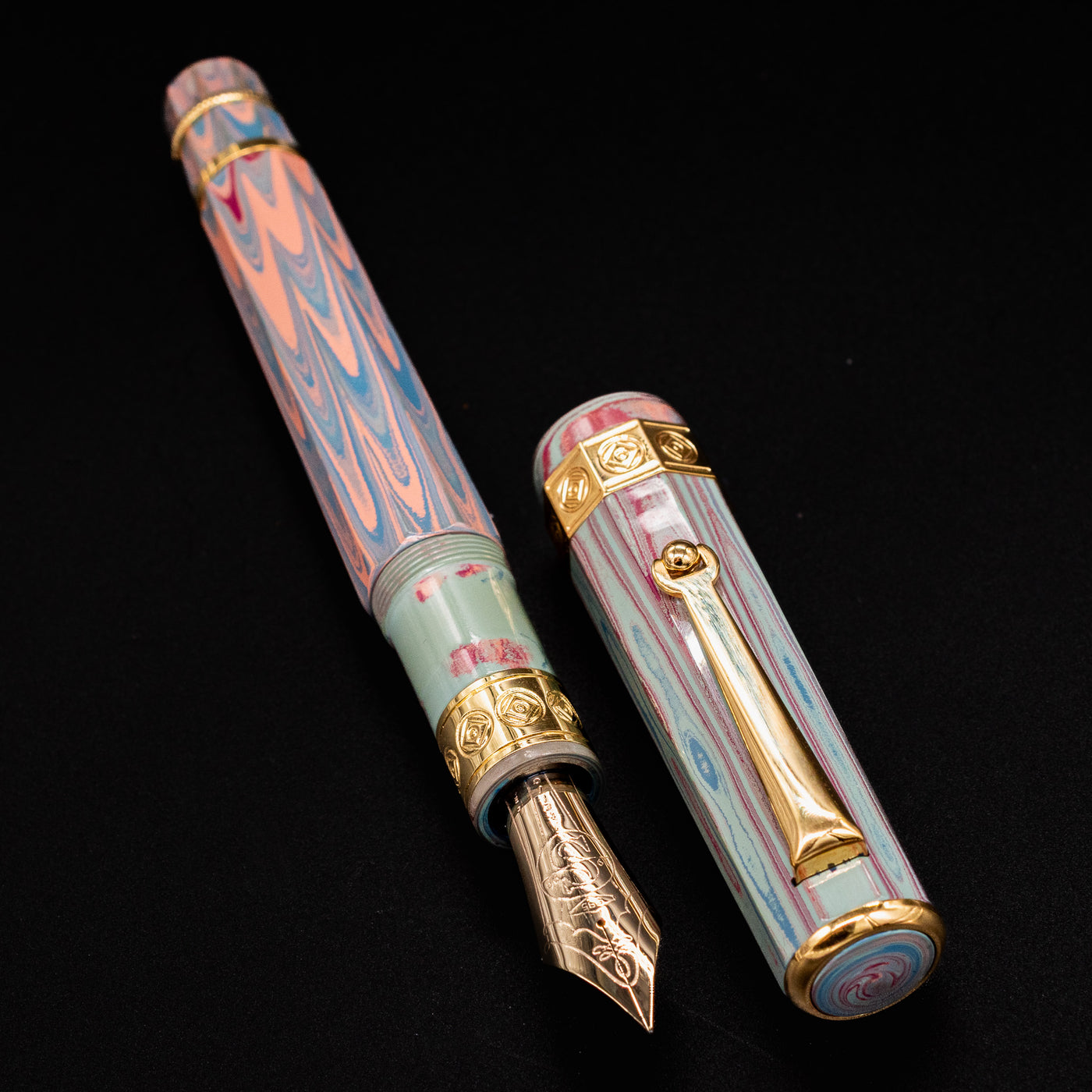 Santini Giant 8 Faceted Burano Fountain Pen with cap off, displaying its gold nib, vibrant marbled resin body, and decorative gold trim.