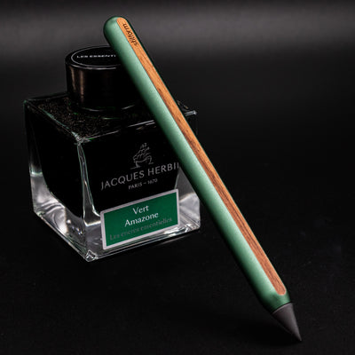 Stilform AEON Pencil Aurora Green - leaning on ink bottle