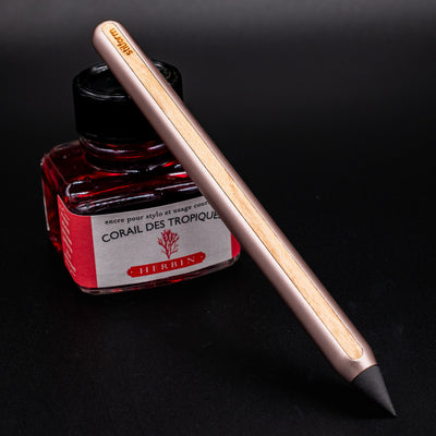 Stilform AEON Pencil Rose Moon Aluminum - leaning on ink bottle