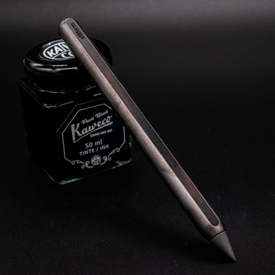 Stilform AEON Pencil Titanium DLC - leaning on ink bottle