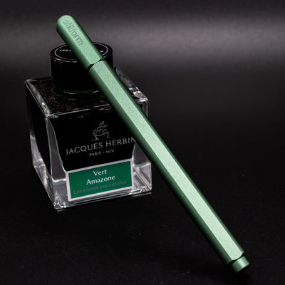 Stilform ARC Gel Pen Aurora Green - capped and leaning on ink bottle