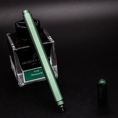 Stilform ARC Gel Pen Aurora Green - uncapped and leaning on ink bottle
