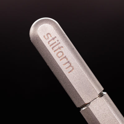 Stilform ARC Gel Pen Comet Grey - closeup of Stilform logo on barrel