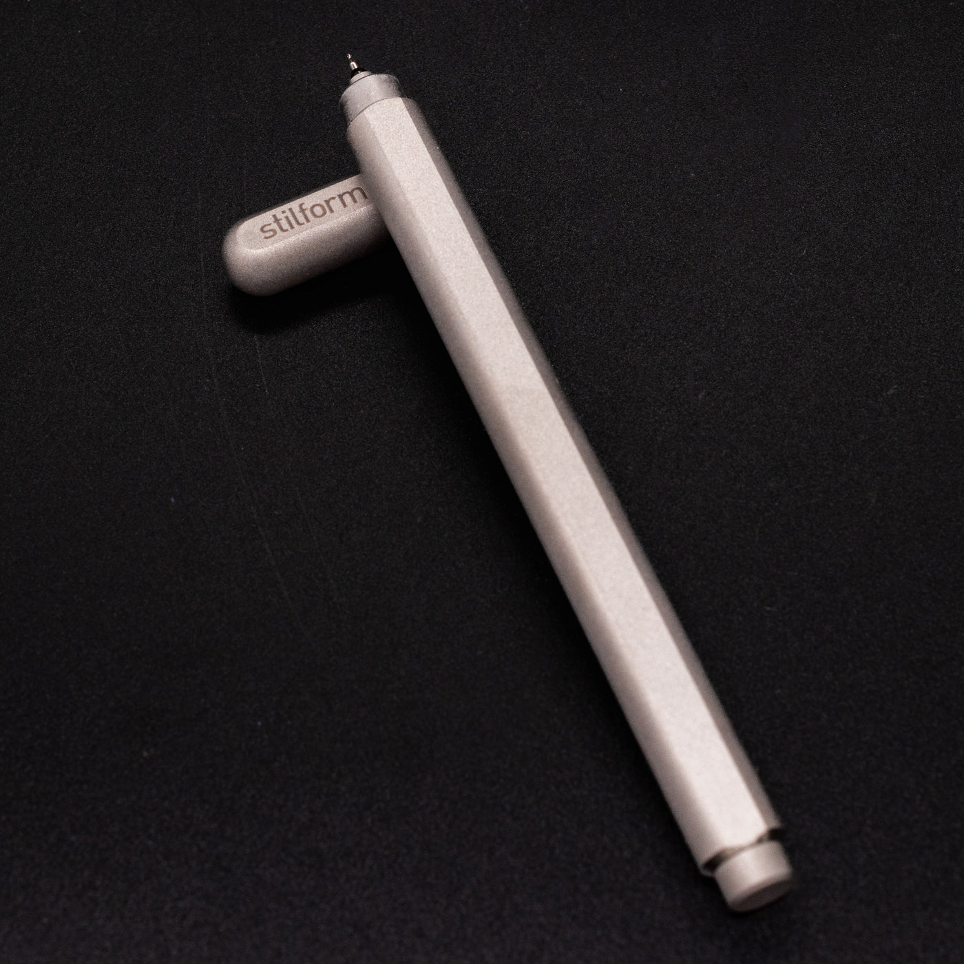 Stilform ARC Gel Pen Comet Grey - barrel leaning on cap, uncapped view