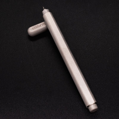 Stilform ARC Gel Pen Comet Grey - barrel leaning on cap, uncapped view
