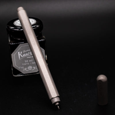 Stilform ARC Gel Pen Comet Grey - uncapped and leaning on ink bottle