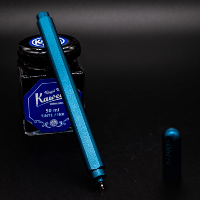 Stilform ARC Gel Pen Night Sky Aluminum - uncapped and leaning on ink bottle