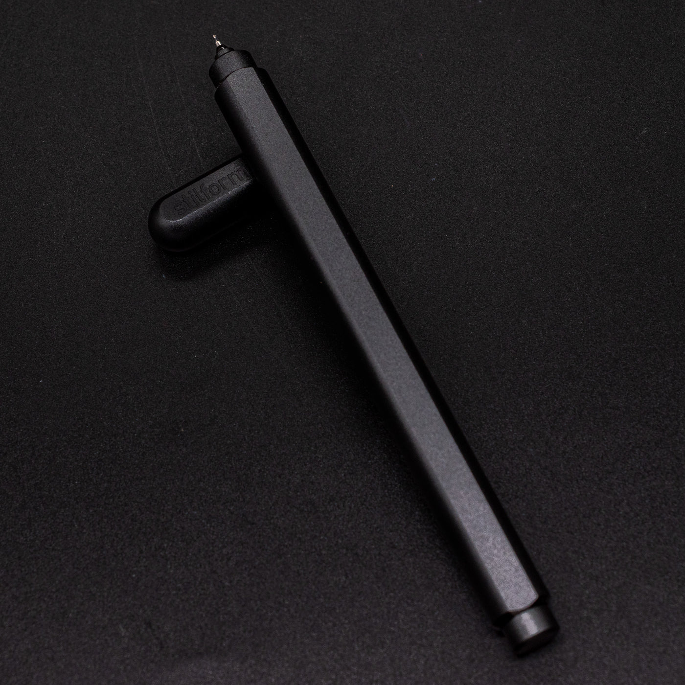 Stilform ARC Gel Pen Titanium DLC - barrel leaning on cap, uncapped view