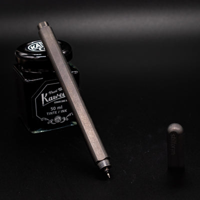 Stilform ARC Gel Pen Titanium Matte - uncapped and leaning on ink bottle