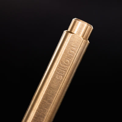 Stilform FLOW Rollerball Pen Brass Radial Brushed - closeup of Stilform logo on barrel