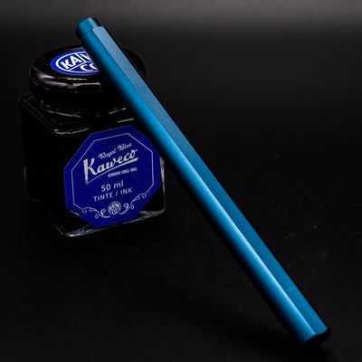 Stilform FLOW Rollerball Pen Night Sky Aluminum - capped and leaning on ink bottle