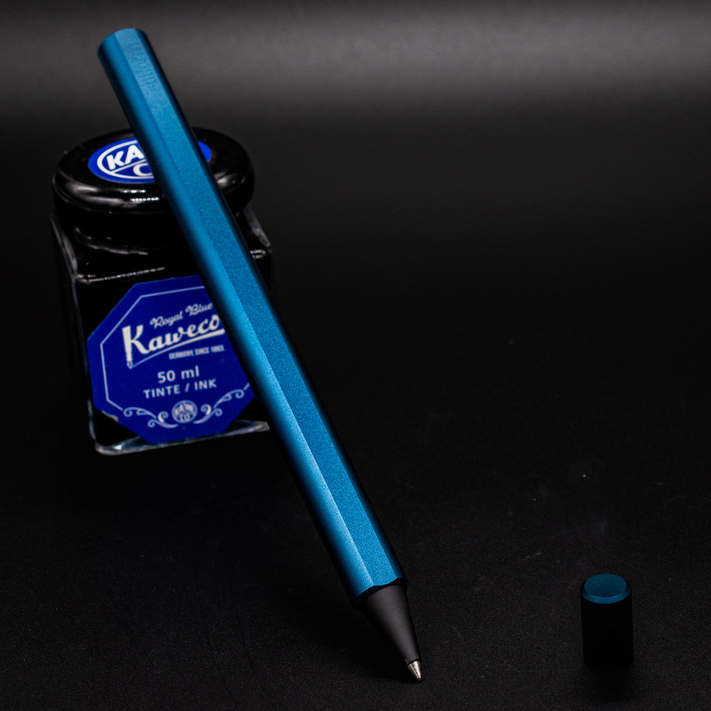 Stilform FLOW Rollerball Pen Night Sky Aluminum - uncapped and leaning on ink bottle