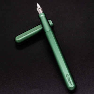 Stilform INK Fountain Pen Aurora Green – barrel leaning on cap, uncapped view