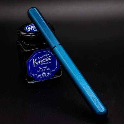 Stilform INK Fountain Pen  – Night Sky capped and leaning on ink bottle