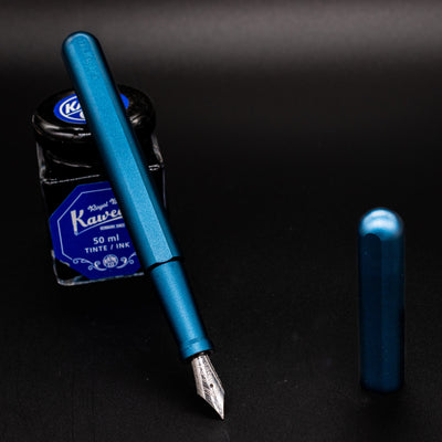 Stilform INK Fountain Pen Night Sky – uncapped and leaning on ink bottle