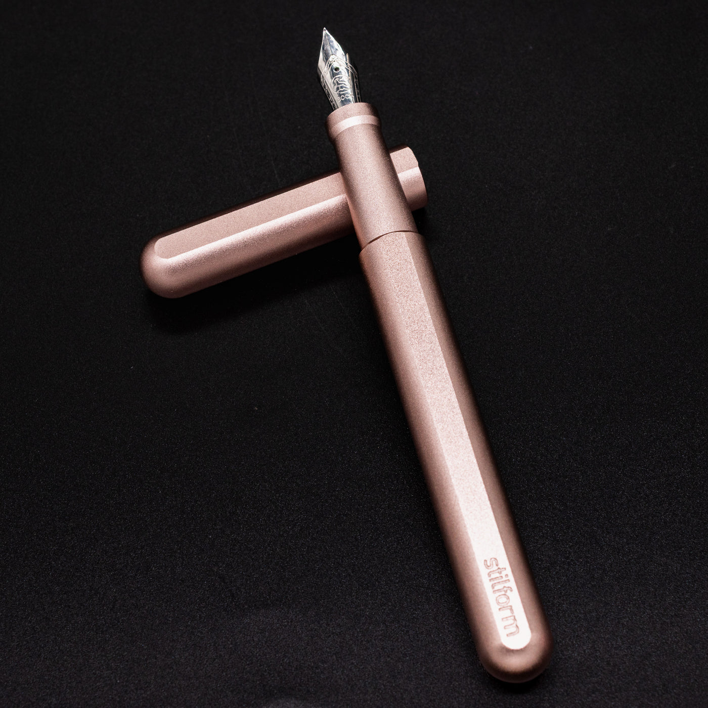 Stilform INK Fountain Pen Rose Moon Aluminum – barrel leaning on cap, uncapped view