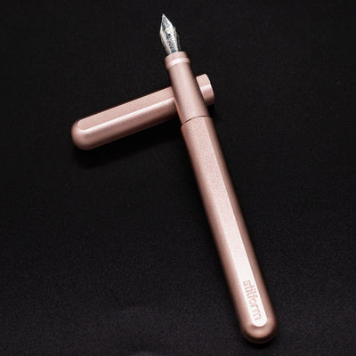 Stilform INK Fountain Pen Rose Moon Aluminum – barrel leaning on cap, uncapped view