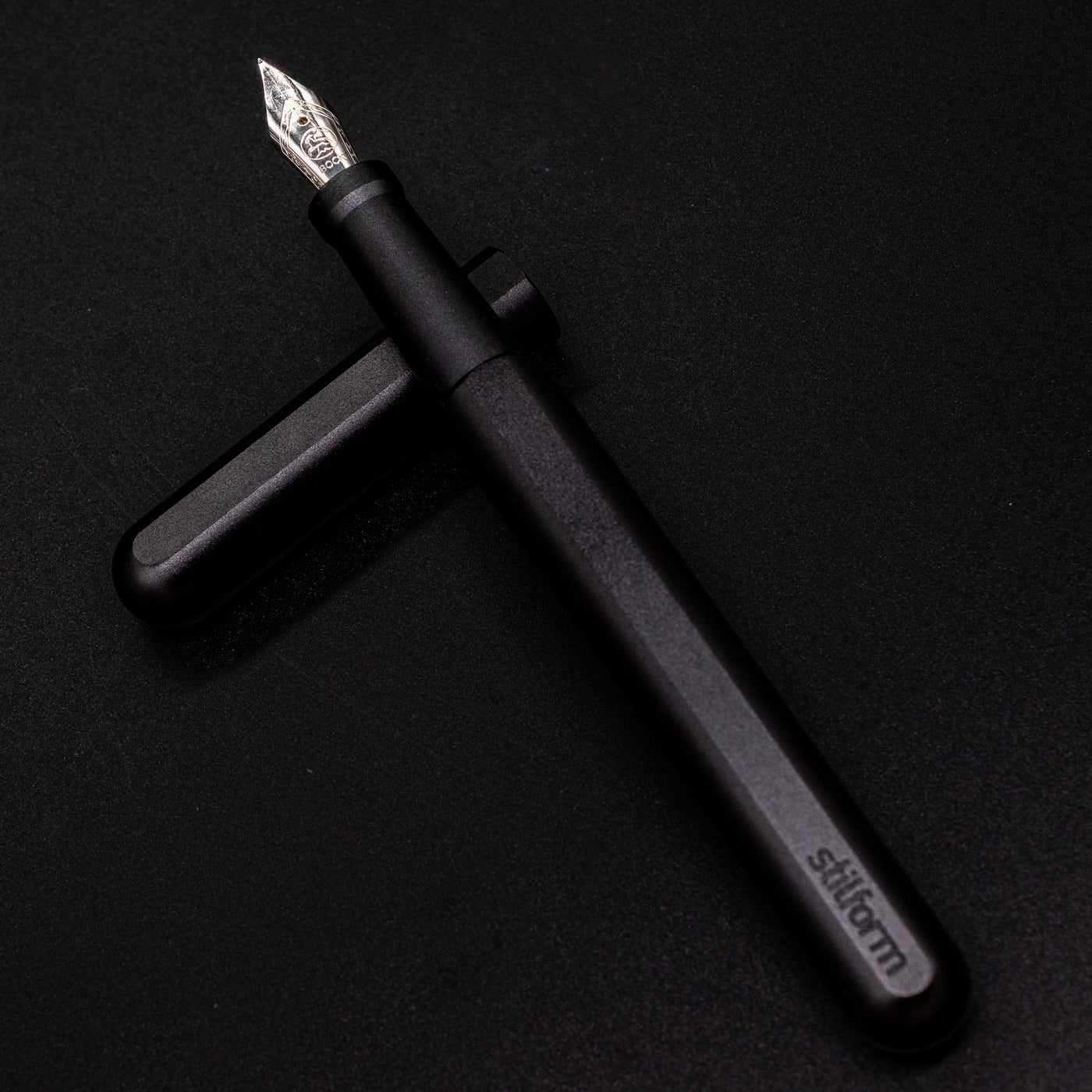 Stilform INK Fountain Pen Titanium DLC – barrel leaning on cap, uncapped view