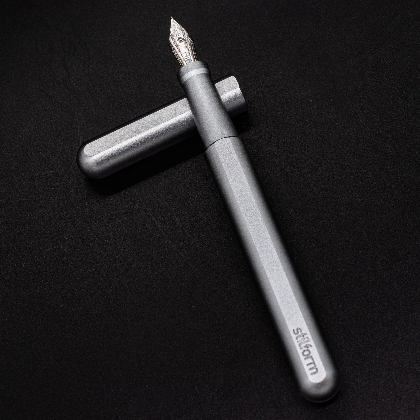Stilform INK Fountain Pen Warp Black – barrel leaning on cap, uncapped view