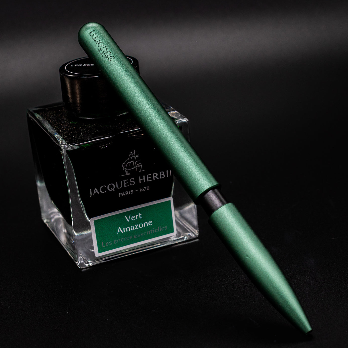Stilform PEN Ballpoint Pen Aurora Green - pen leaning on ink bottle