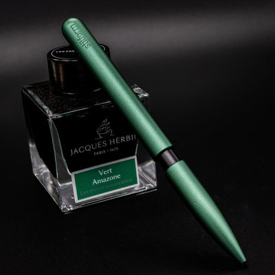 Stilform PEN Ballpoint Pen Aurora Green - pen leaning on ink bottle