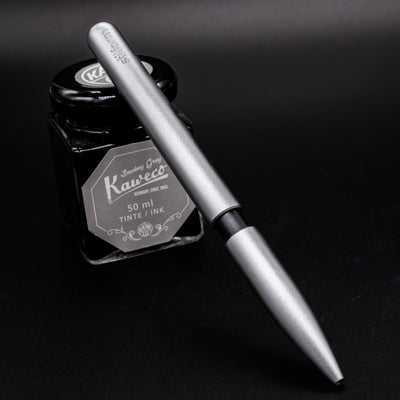 Stilform PEN Ballpoint Pen Comet Grey - pen leaning on ink bottle