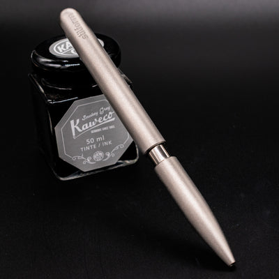 Stilform PEN Ballpoint Pen Titanium Matte - pen leaning on ink bottle
