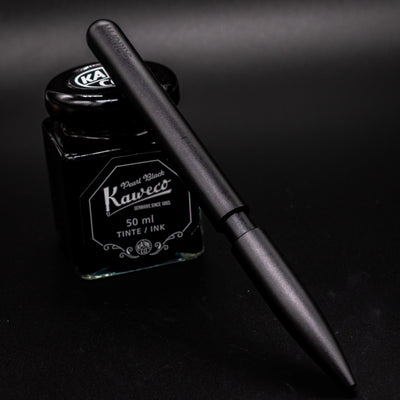 Stilform PEN Ballpoint Pen Warp Black - pen leaning on ink bottle