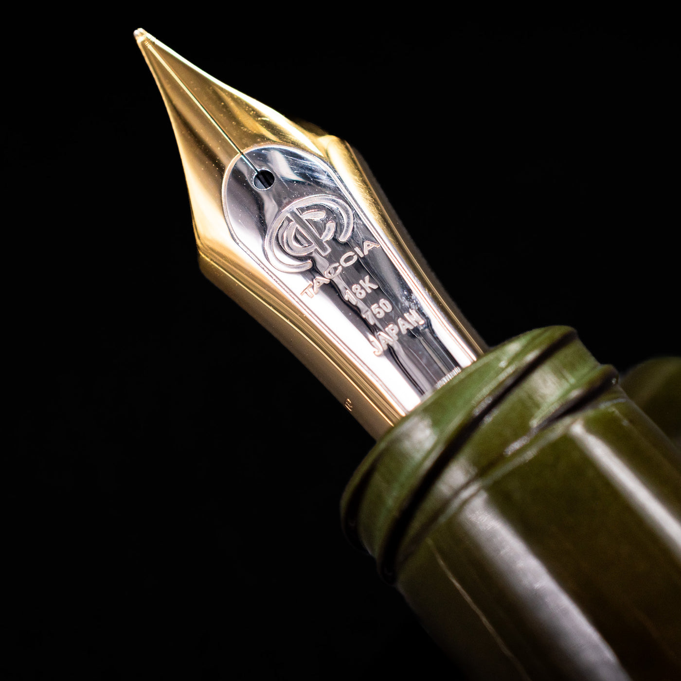 Macro shot of Taccia fountain pen 18k gold nib engraved with Taccia logo and “Japan” detailing