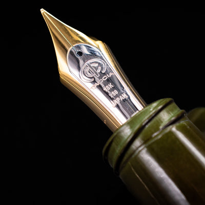 Macro shot of Taccia fountain pen 18k gold nib engraved with Taccia logo and “Japan” detailing