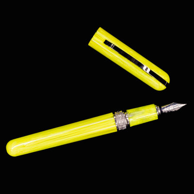 Flat lay of uncapped Visconti Breeze Fountain Pen in Lemon with visible nib and section
