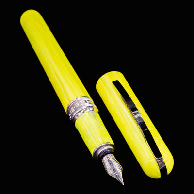 Visconti Breeze Lemon fountain pen displayed side by side with its cap on a black background