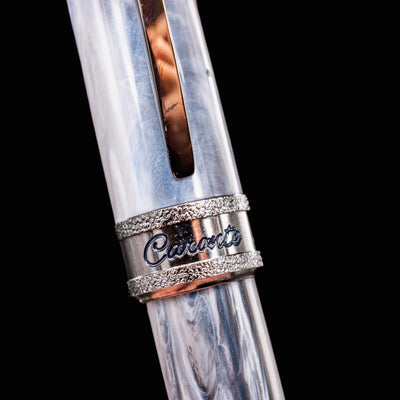 Macro image of Visconti Comedia Caronte cap band with engraved Caronte name and textured metal trim.
