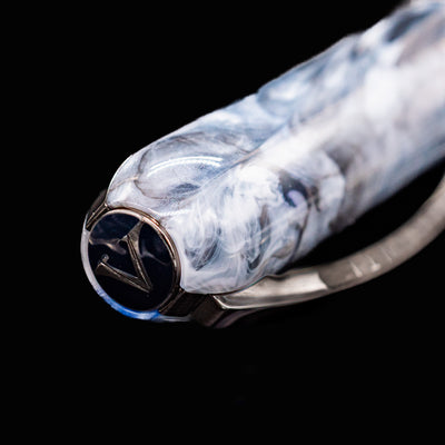 Close-up of Visconti Comedia Caronte Fountain Pen cap finial featuring the Visconti 'V' logo.