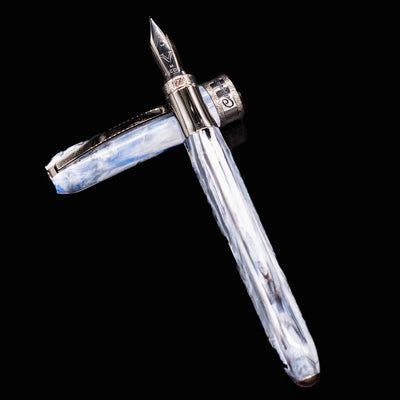 Detailed image of Visconti Comedia Caronte nib and cap, showcasing metal grip and swirling resin.