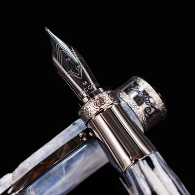 Extreme close-up of Visconti Comedia Caronte Fountain Pen nib with engraved Visconti logo.