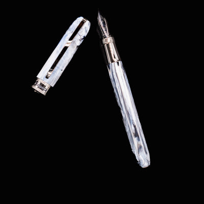 Diagonal view of Visconti Comedia Caronte Fountain Pen with cap removed and nib exposed.
