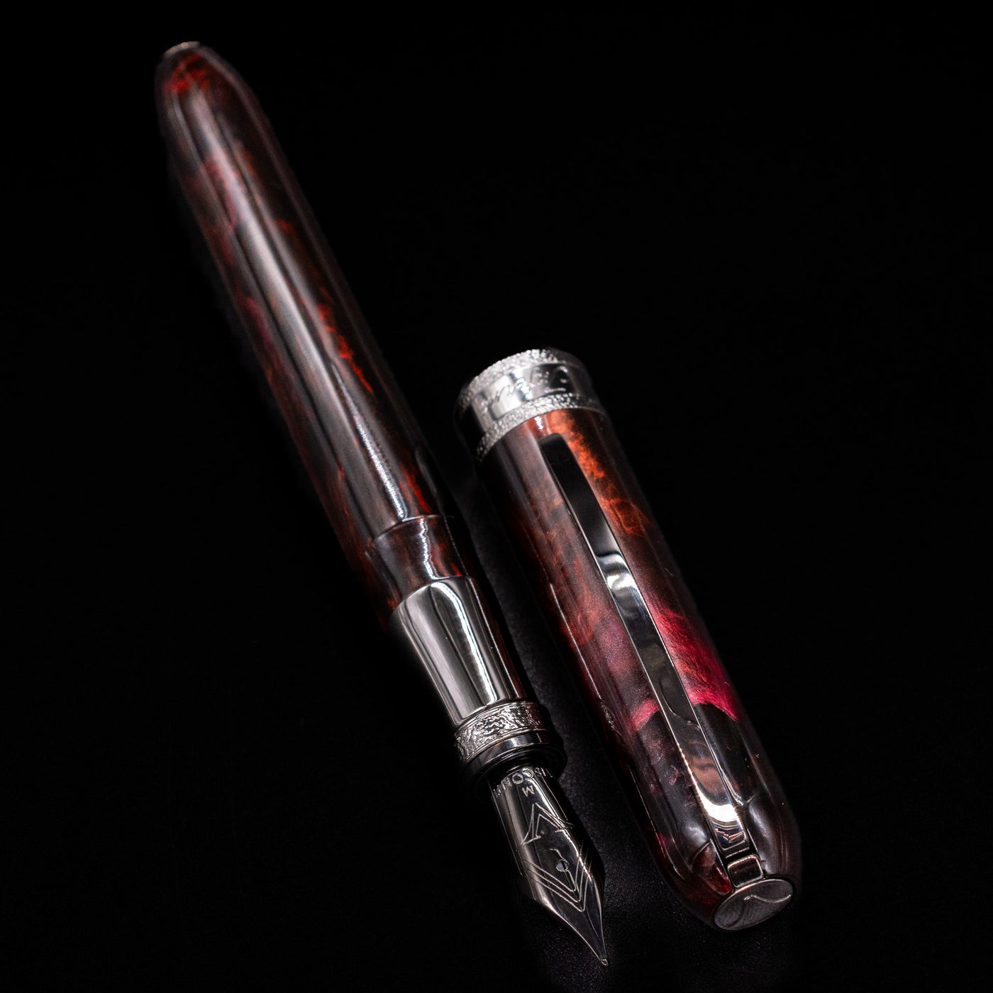 Visconti Comedia Inferno Fountain Pen with detailed view of cap and shimmering resin body