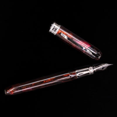 Full view of the Visconti Comedia Inferno Fountain Pen and cap side by side on black surface