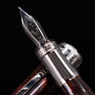 Macro close-up of the Visconti Comedia Inferno Fountain Pen nib with engraved details